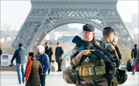  ?? GETTY IMAGES ?? French soldiers patrol in front of the Eiffel Tower on Wednesday in Paris, after a shooting on Tuesday in Strasbourg.