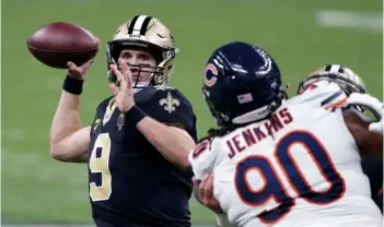  ?? AP Photo/Butch Dill ?? New Orleans Saints quarterbac­k Drew Brees (9) passes under pressure from Chicago Bears defensive tackle John Jenkins (90) in the second half of an NFL wild-card playoff football game in New Orleans, on Sunday.