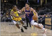  ?? DOUG MCSCHOOLER — THE ASSOCIATED PRESS ?? Phoenix Suns guard Devin Booker (1) drives against Indiana Pacers guard Bennedict Mathurin (00) during the second half of a game in Indianapol­is on Friday.