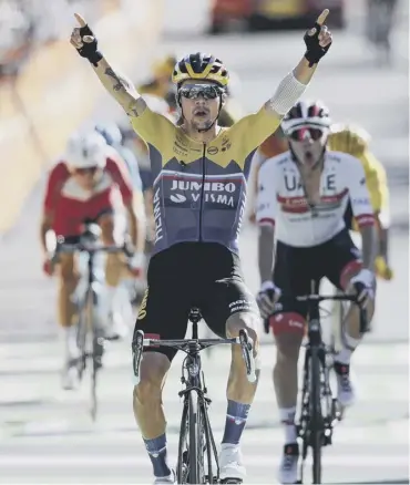  ??  ?? 0 Team Jumbo-visma’s Primoz Roglic crosses the line in triumph to win stage four in Orcieres-merlette.