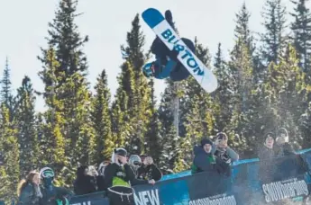  ?? Hyoung Chang, The Denver Post ?? Eagle teenager Jake Pates, a U.S. Olympian, catches big air while competing in snowboard superpipe at the Dew Tour stop in Breckenrid­ge in December.