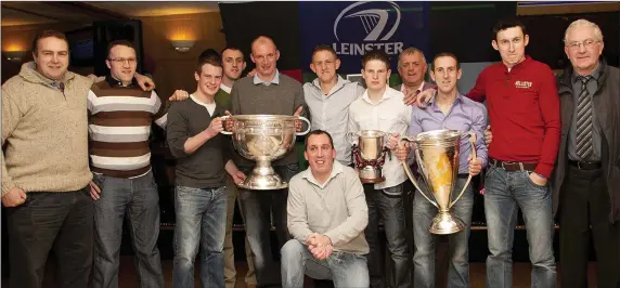  ??  ?? A BLAST FROM THE PAST - Players and mentors pose with some famous trophies at a fundraisin­g function for St Mary’s Club in Parkview House, Shillelagh in December 2011.