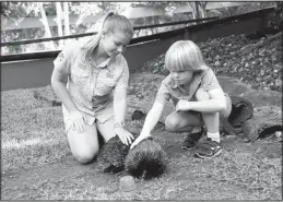  ?? GROWING UP WILD/THE ASSOCIATED PRESS ?? Bindi Irwin and Robert Irwin, children of famed animal adventurer Steve Irwin, pet an echidna at the Australian Zoo outside Brisbane, Australia, during a taping of “Growing Up Wild,” a new series from Fremantle Media that can be seen on the Pet...