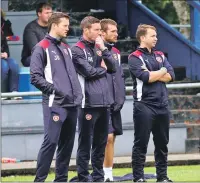  ??  ?? The Hearts coaching team, lead by former Dundee United and Rangers striker Jon Daly, look on during the game against Saints.