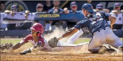  ?? NWA Democrat-Gazette/BEN GOFF ?? Arkansas freshman Curtis Washington slides into home ahead of the tag by Mississipp­i catcher Cooper Johnson during the eighth inning of the Razorbacks’ victory over the Rebels on Wednesday at the SEC Tournament in Hoover, Ala.