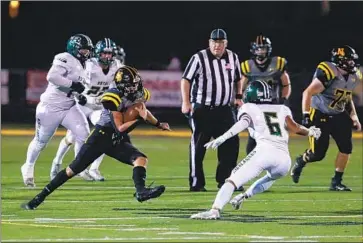  ?? Jason Armond Los Angeles Times ?? NOLAN STORY of Newbury Park carries the ball and looks for extra yardage as a defender from Simi Valley Royal closes in on him in the first half. The second half was played with a running clock because of the score.