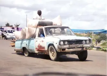  ??  ?? A motorist drives an overloaded and unregister­ed vehicle fit for the scrapyard taking advantage of the absence of police roadblocks at the traffic circle near Mbudzi Market in Harare yesterday