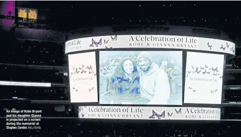  ?? REUTERS ?? An image of Kobe Bryant and his daughter Gianna is projected on a screen during the memorial at Staples Center.