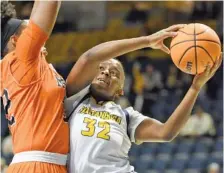  ?? STAFF PHOTO BY MATT HAMILTON ?? Mercer’s Jaron Dougherty, left, defends as UTC’s Raven Thompson drives to the basket during Saturday’s game at McKenzie Arena. Thompson had 23 points, seven rebounds and three steals in the Mocs’ victory.