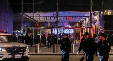  ??  ?? NYPD officers stand near the Time Warner Centre Building after the building was evacuated due to a bomb threat. — Reuters photo