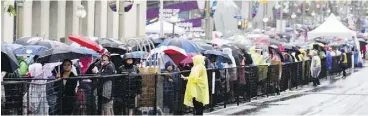  ?? DARREN BROWN / POSTMEDIA NEWS ?? Thousands of people lined up for hours in the pouring rain for security checks near Parliament Hill in Ottawa during a Canada Day celebratio­n that some called a “fiasco.”