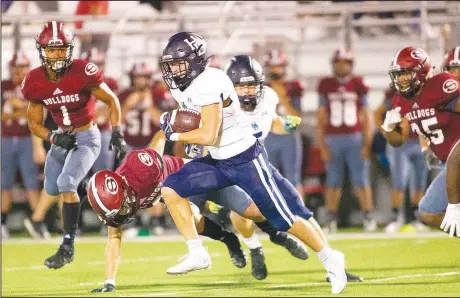  ?? (Special to NWA Democrat-Gazette/David Beach) ?? Springdale Har-Ber’s Lane Reiter (center) runs the ball against Springdale on Friday at Jarrell Williams Bulldog Stadium in Springdale.