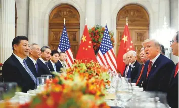  ?? AP ?? US President Donald Trump with China’s President Xi Jinping and officials of both countries during their meeting on Saturday at the G20 summit in Buenos Aires.