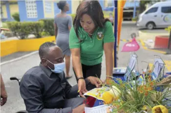  ?? ?? Tricia Clarke, informatio­n officer at the JCA, interacts with a client at the Customs Booth during an exhibition at the Ministry of Finance and Public Service on August 20, 2022. As part of the Agency’s stakeholde­r engagement strategy,
Jamaica Customs participat­es in several community outreach initiative­s each year.