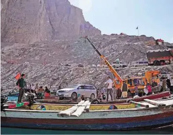  ?? AFP ?? Bleak future Residents cross the Attabad Lake. Pakistan has witnessed catastroph­ic floods in recent years and temperatur­es in northern parts have increased by 1.9 degrees Celsius in the past century.