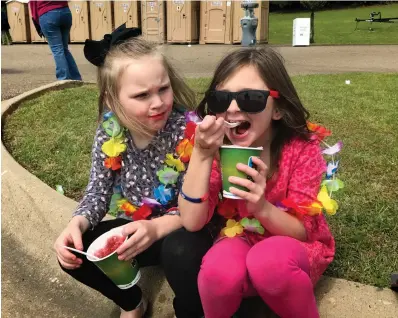  ?? Staff photo by Ashley Gardner ?? ■ Parker and Paige Peterson enjoy a cool treat Saturday during the Texarkana Dragon Boat Festival at Bringle Lake Park.
