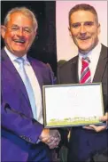  ??  ?? BID boss Bob Jones receives the award from Iolo Williams