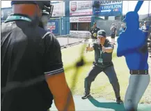  ?? Eva Russo/Richmond Times-Dispatch file photo via AP ?? Umpire Jen Pawol works with students during MLB umpire camp at The Diamond in Richmond, Va., in 2022. Pawol is on the verge of becoming Major League Baseball’s first woman umpire.