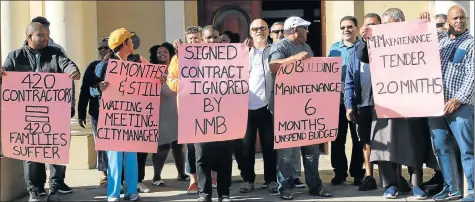  ?? Picture: FREDLIN ADRIAAN ?? SEEKING ANSWERS: Small municipal maintenanc­e contractor­s protest at the City Hall yesterday