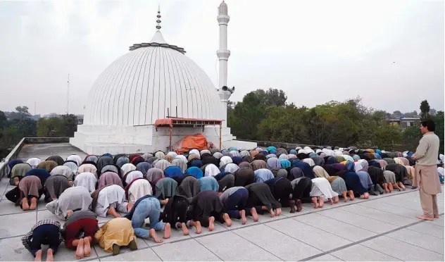  ?? Agence France-presse ?? People offer Friday prayers as the government announced to observe a ‘Day of Prayer’ for the coronaviru­s pandemic at a mosque in Islamabad.
