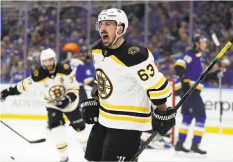  ?? Jeff Roberson / Associated Press ?? Boston’s Brad Marchand celebrates after giving his team a 1-0 lead midway through the first period. The Bruins then took control by scoring four times in the third period.