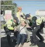  ??  ?? Police restrain a demonstrat­or in Kirby Misperton on Tuesday.