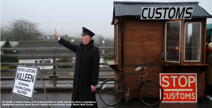  ??  ?? GO SLOW: A mock customs post at Ravensdale, Co Louth, last week where campaigner­s highlighte­d concerns about Brexit’s impact on cross-border trade. Photo: Niall Carson