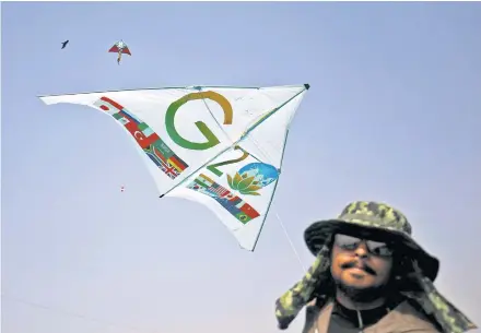  ?? REUTERS ?? A kite enthusiast flies a kite on Jan 8 featuring the G20 logo during the eight-day-long Internatio­nal Kite Festival in Ahmedabad, India.