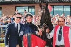  ?? Rex Features ?? Trainer Joseph O’Brien with his brother Donnacha O’Brien and Latrobe pose after their winning performanc­e.