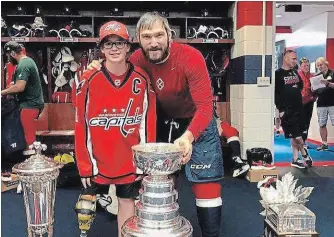  ?? SPECIAL TO THE NIAGARA FALLS REVIEW ?? Niagara Falls teen Alex Luey celebrates with his hero, Washington Capitals superstar and captain Alex Ovechkin, with the Stanley Cup in the team’s locker room before taking in the club’s victory parade on Tuesday.