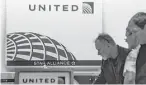  ?? Timothy Fadek / Bloomberg ?? Passengers use United self check-in kiosks at the Newark, N.J., airport.