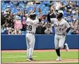  ?? JON BLACKER - THE ASSOCIATED PRESS ?? Detroit Tigers’ Miguel Cabrera, right, rounds the bases after hitting his 500th career home run in the sixth inning against the Toronto Blue Jays during a baseball game in Toronto, Sunday, Aug. 22, 2021.