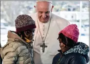  ?? (AP/Louisa Gouliamaki) ?? Pope Francis greets children during a Sunday ceremony at the Karatepe refugee camp on the northeaste­rn Aegean island of Lesbos, Greece. More photos at arkansason­line.com/126francis/.