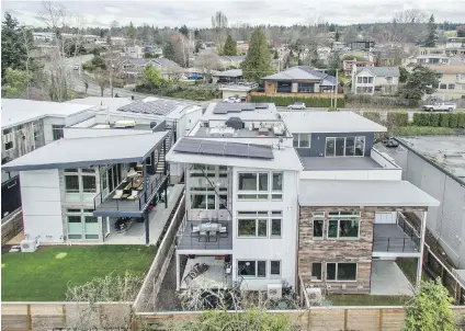  ??  ?? Chris and Deborah Voss were the first residents of the Lakeview Solar Community in Kirkland, Washington, to install their rooftop solar panels (their three-level duplex is second from right). The solar-ready community is designed to help homeowners...