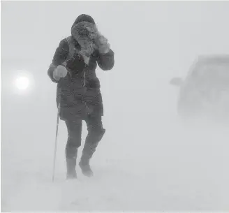  ??  ?? A pedestrian walks down a street near Citadel Hill in Halifax as a major storm blasted the Maritimes.