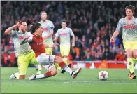  ?? KIRSTY WIGGLESWOR­TH / AP ?? Hector Bellerin slides in to score Arsenal's third goal during its 3-1 Europa League Group H victory over Cologne at Emirates Stadium in London on Thursday.