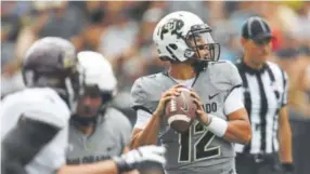  ?? Andy Cross, The Denver Post ?? CU quarterbac­k Steven Montez, a sophomore from El Paso, looks for a passing lane during Saturday’s game against Texas State in Boulder.
