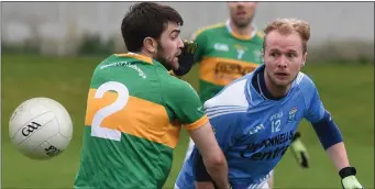  ??  ?? Newtown Blues’ Conor McQuillan attempts to round Sean O’Mahony’s Mickey Clarke.