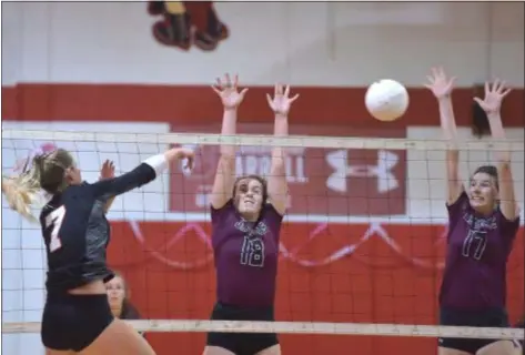  ?? PETE BANNAN — DIGITAL FIRST MEDIA ?? Archbishop Carroll’s Paige Monastero, left, hits a ball into the block of Garnet Valley’s Rachel Cain, center, and Ally Hartney Wednesday. The Jaguars picked up a 3-1 nonleague win.