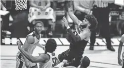  ?? MICHAEL CONROY/AP ?? Michigan forward Isaiah Livers (2) shoots over Purdue forward Trevion Williams (50) during the first half Friday in West Lafayette, Ind.