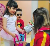  ?? BRUCE EDWARDS/ POSTMEDIA NEWS ?? Isabella Brezden, 5, and brother Maxwell, 3, trick-or-treat at the Maier Centre for Autism Services in Edmonton.