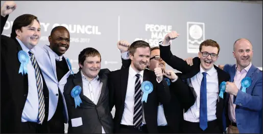  ??  ?? From left, Kyle Thornton, Ade Aibinu, Robert Connolly, David Meikle, Thomas Kerr, Euan Blockley, Tony Curtis and Phillip Charles show their joy at winning seats as the election saw the Conservati­ves make big gains