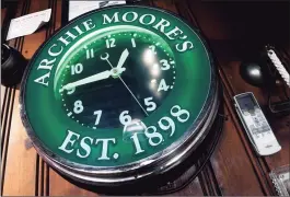  ?? Arnold Gold / Hearst Connecticu­t Media ?? An Archie Moore’s clock hangs at the end of the bar during the restoratio­n.