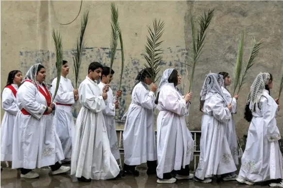  ?? AFP ?? Catholics take part in a Palm Sunday service in Erbil, in Iraq’s semi-autonomous Kurdish region, before the church cancelled Easter events in the country
