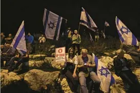  ?? AHMAD GHARABLI/GETTY-AFP ?? Demonstrat­ors waving Israeli flags gather Thursday outside the Knesset in Jerusalem to protest the government’s controvers­ial justice reform bill.