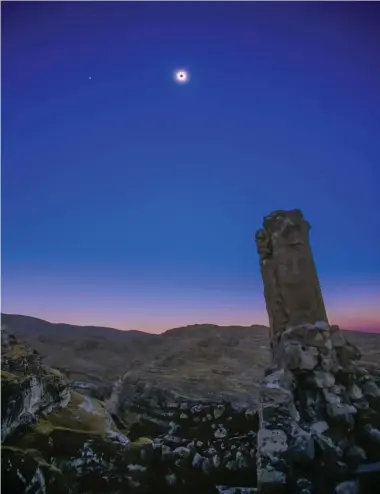  ?? ALAN DYER ?? Photograph­ed Aug. 11, 1999, from Hasankayef — a village and archeologi­cal site along the Tigris River in southest Turkey — a total solar eclipse dazzles high in the sky above fortress ruins in the foreground. It’s hard to imagine what the people who used to live in the homes built into the valleys some 2,000 years ago would have thought if they saw such an unfamiliar sight.