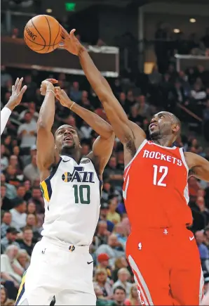  ?? RICK BOWMER / AP ?? Luc Mbah a Moute of the Houston Rockets blocks a shot by Utah Jazz’s Alec Burks during the Rockets’ 96-85 victory in Salt Lake City on Monday. James Harden scored 26 points and snagged 11 rebounds and Mbah a Moute scored 15 of his 17 points in the...