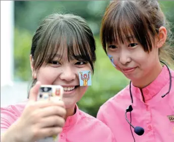  ?? AN XIN / FOR CHINA DAILY ?? Chinese employees of McDonald’s take a selfie at a promotion event in Nanjing, Jiangsu province.