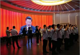  ?? REUTERS ?? People recite the party oath in front of a screen showing Chinese President Xi Jinping during an event marking the 100th founding anniversar­y of the Communist Party of China at the Memorial of the First National Congress of the Communist Party of China in Shanghai, China on Friday.