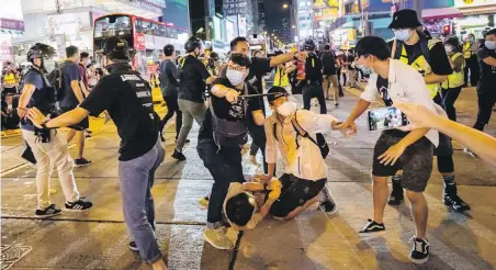  ??  ?? Undercover police arrest participan­ts of a memorial vigil in Hong Kong on Thursday. Thousands gathered for the annual memorial vigil in Victoria Park to mark the 1989 Tiananmen Square Massacre despite a police ban.